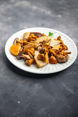 mushroom salad mix white mushroom, boletus mushroom, chanterelle mushroom, ready to eat meal food snack on the table copy space food background rustic top view