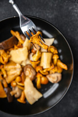 mushroom salad mix white mushroom, boletus mushroom, chanterelle mushroom, ready to eat meal food snack on the table copy space food background rustic top view