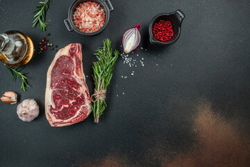New York steak with salt and rosemary, raw marbled beef strip loin steak on a dark background, Long banner format. top view