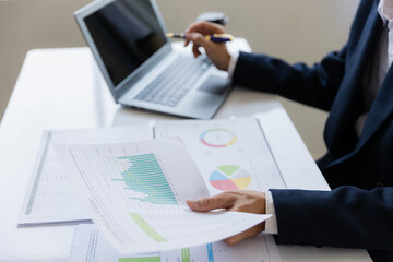 Male businessman working with calculator, business document and laptop computer notebook at room office.