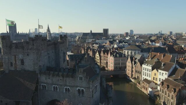 Panning right past Gravensteen castle and canal in Ghent Belgium
