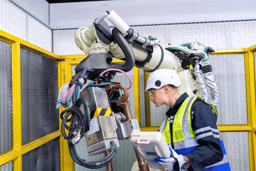 Engineer service robot welding in factory software programming operation test and commissioning