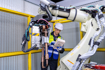 Engineer service robot welding in factory software programming operation test and commissioning