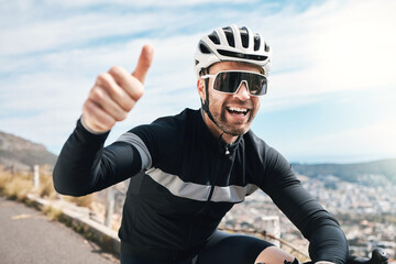 What an awesome ride. a handsome mature man gesturing thumbs up while cycling outdoors.