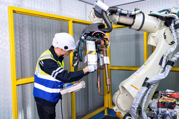 Engineer service robot welding in factory software programming operation test and commissioning