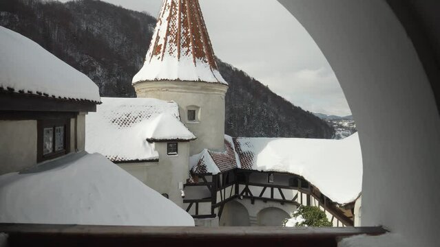 View from the windows on high towers and roof tops at ancient castle covered with snow.