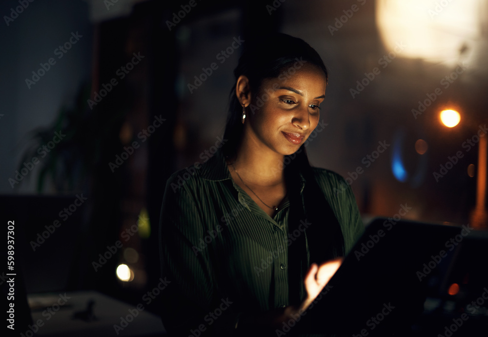 Poster she gets it all done with efficiency. a young businesswoman using a digital tablet in an office at n