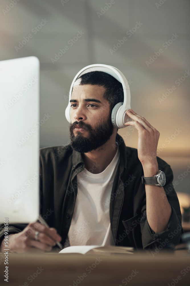 Poster brilliant designs inspired by brilliant music. a young businessman writing in a notebook and using a