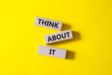 Think about it symbol. Wooden blocks with words Think about it. Beautiful yellow background. Business and Think about it concept. Copy space.