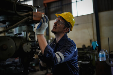 Lathe Operators Concentrated on Work. Worker in uniform and helmet works on lathe, factory. Industrial production, metalwork engineering, manufacturing.