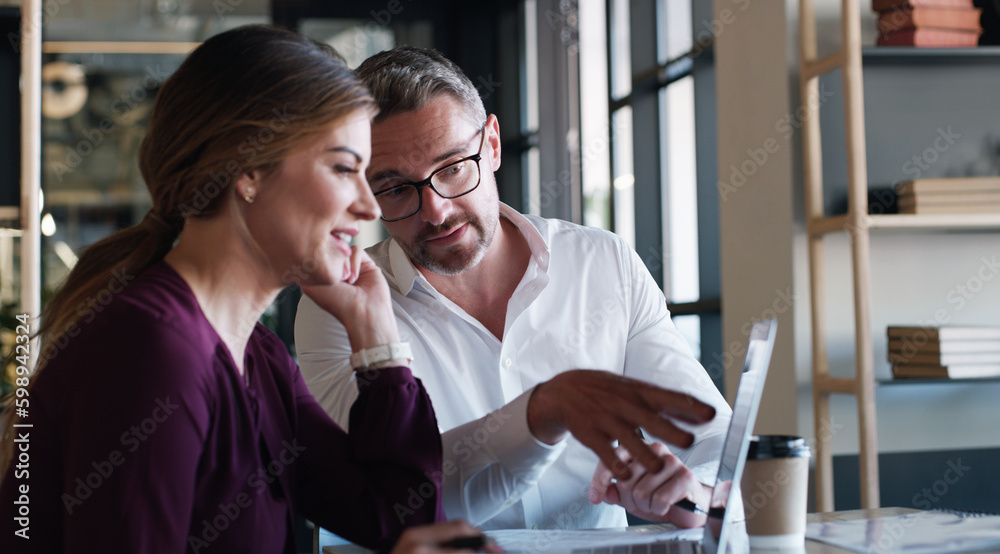 Poster collaboration that keeps the progress coming. a businessman and businesswoman using a laptop and hav