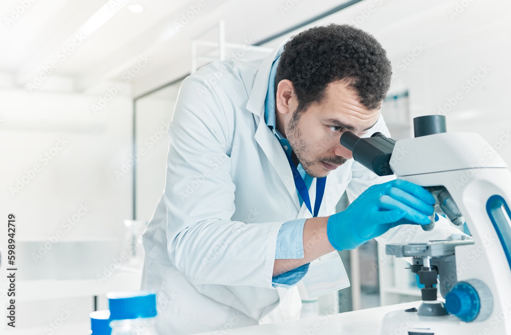 Canvas Prints Making sense of little parts. a young scientist using a microscope in a lab.