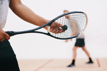 Its all in how you serve. a man serving a ball with a racket during a game of squash.