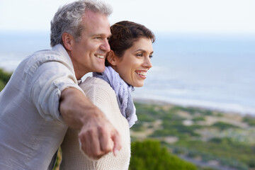 Look at that amazing view. A happy mature couple looking at an amazing view.