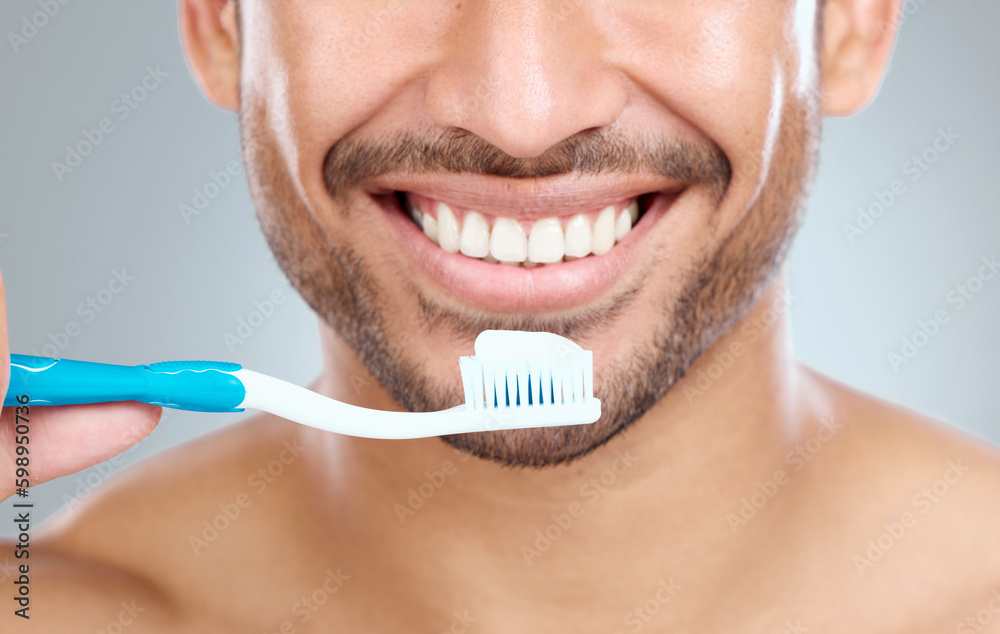 Aufkleber remember to use a soft bristle brush. a man holding his toothbrush while standing against a grey bac