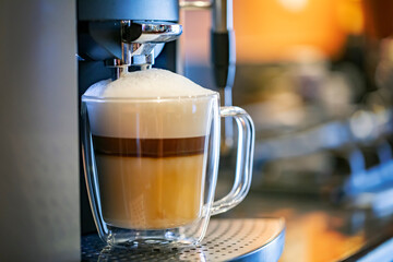 Fototapeta na wymiar Coffee latte in a glass on the coffee machine
