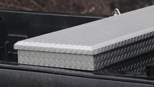 Detail view of pickup truck crossbed toolbox
