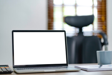 Empty white screen laptop. blank white screen. Mockup image in office.