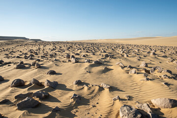 Fototapeta na wymiar Barren desert landscape in hot climate with geological watermelons