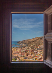 Fototapeta na wymiar Through a window of the Alcazaba of Almería, views of the port and old town, Andalusia, Spain