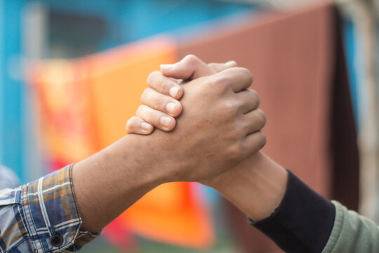 Two hands clasped together and background blurred