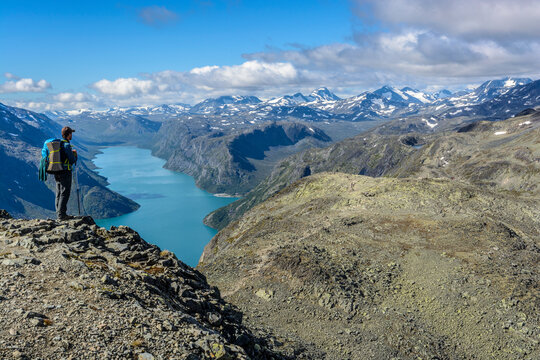Wanderer auf dem Besseggen Grat mit Blick auf Gjende See, Jotunheimen Nationalpark, Norwegen