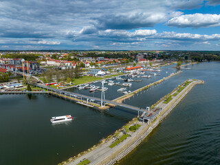 Marina in Gizycko, Poland, Niegocin lake - drone aerial photo of sailboats and bridges, blue cloudy...