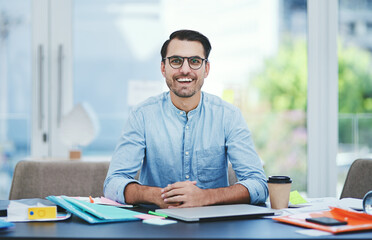 I hope to be leaving a mark with my designs. Portrait of a young designer working in an office.