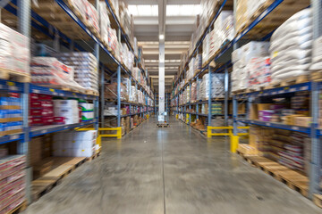 Zoom burst or zoom blur shot of a warehouse for food supplies, no people are visible. - 598973198