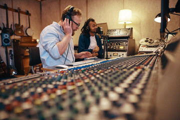 Producer and singer working together during a recording studio session