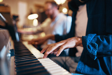 Musician playing keyboards in a recording studio