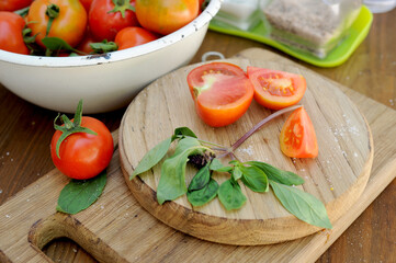 Ripe organic tomatoes at wooden cut boards