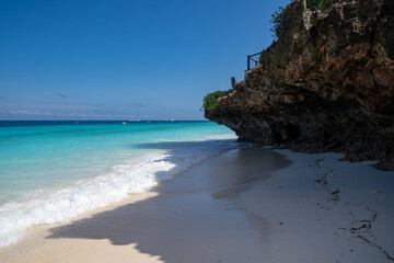 Beautiful rock formation on the shoreline of Zanzibar, Tanzania as an ocean wave rolls in