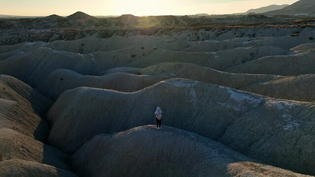 Tourist standing on uneven terrain in desert