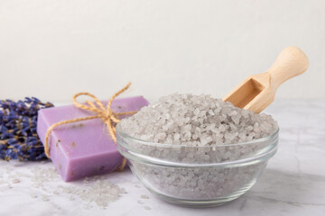 Lavender spa.Sea salt,lavender flowers,aroma candle,body cream and handmade soap.Natural herbal cosmetics with lavender flowers on marble background.Relax concept.Beauty treatments.Copy space.