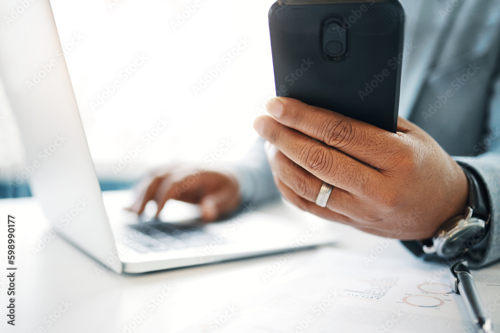 Poster Keeping on top of everything. an unrecognisable businessman sitting alone in the office and using technology.