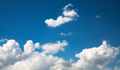 Naklejka na ściany i meble Beautiful fluffy clouds on the blue sky. Sky clouds background.