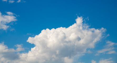 Beautiful huge close-up  fluffy clouds on the blue sky. Sky clouds background.