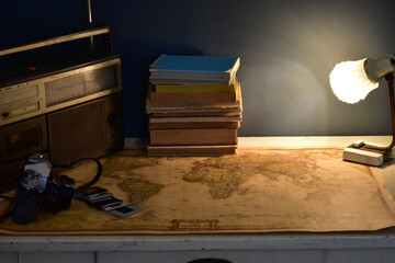 vintage radio and cassette player, old camera and world map on a table