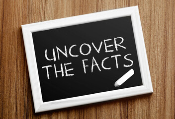 Сhalkboard with text Uncover the facts