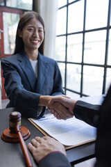 Handshake Close up of photo lawyer male notary working in a courtroom on wooden table office, Legal law, advice deal justice and law concept.	