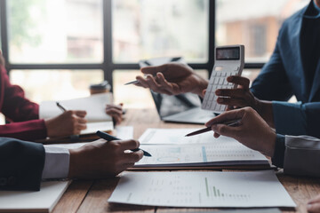 Business people meeting explaining the financial graph data and marketing plan. Group of business people at meeting assessment the state of business investment and marketing...