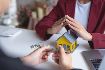 Real estate agent present house and land to their client by offering example of model home...