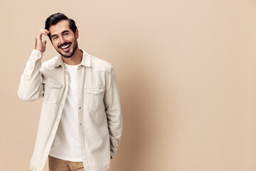 Fototapeta Portrait of a stylish man smile with teeth happiness opened his mouth in surprise on a beige background in a white t-shirt looks at the camera, fashionable clothing style, copy space, Generative AI obraz