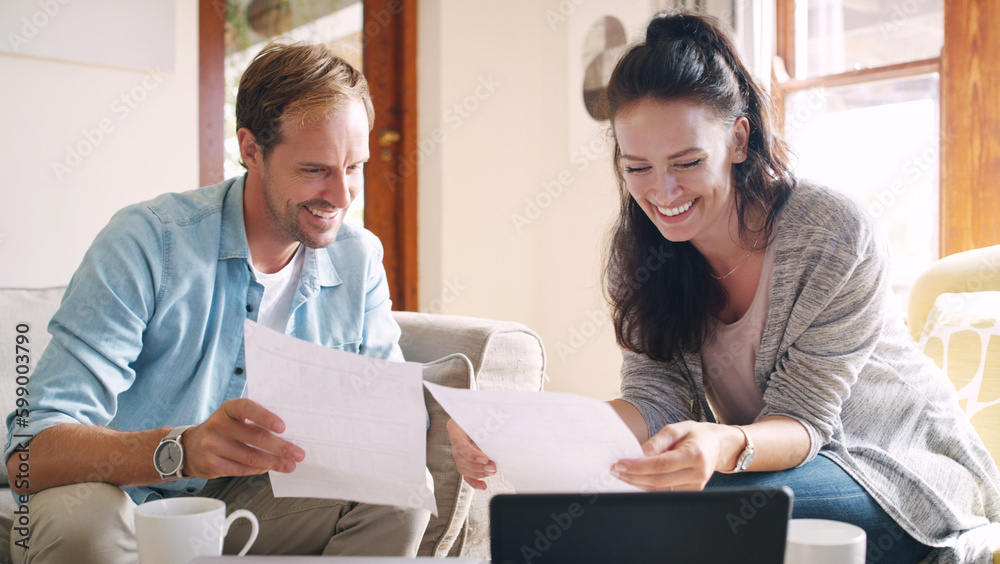 Sticker Well well look who the winners are. an affectionate young couple smiling while going through their budget at home.