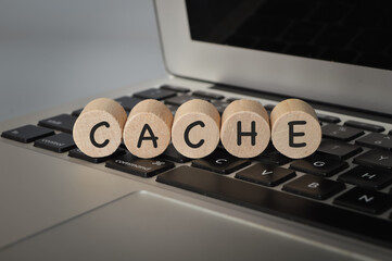 Wooden cube block on computer keyboard with text CACHE