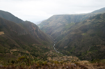 Fototapeta premium Beautiful aerial view of a green valley with river. Saraguro, Ecuador