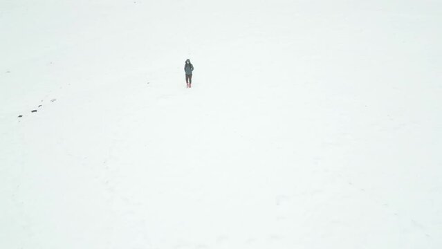 girl walking on a snowy field