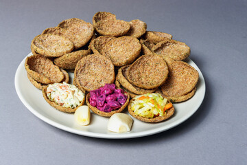 Rye bread toasts on a plate on a gray background