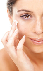 I love the way this makes my skin feel. Studio portrait of a beautiful young woman applying a skincare product to her face.